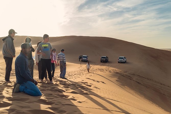 Dubai Desert Bespoke: Red Dunes Safari, Camel Ride & BBQ Options - Sunset photos and sandboarding on the high dune