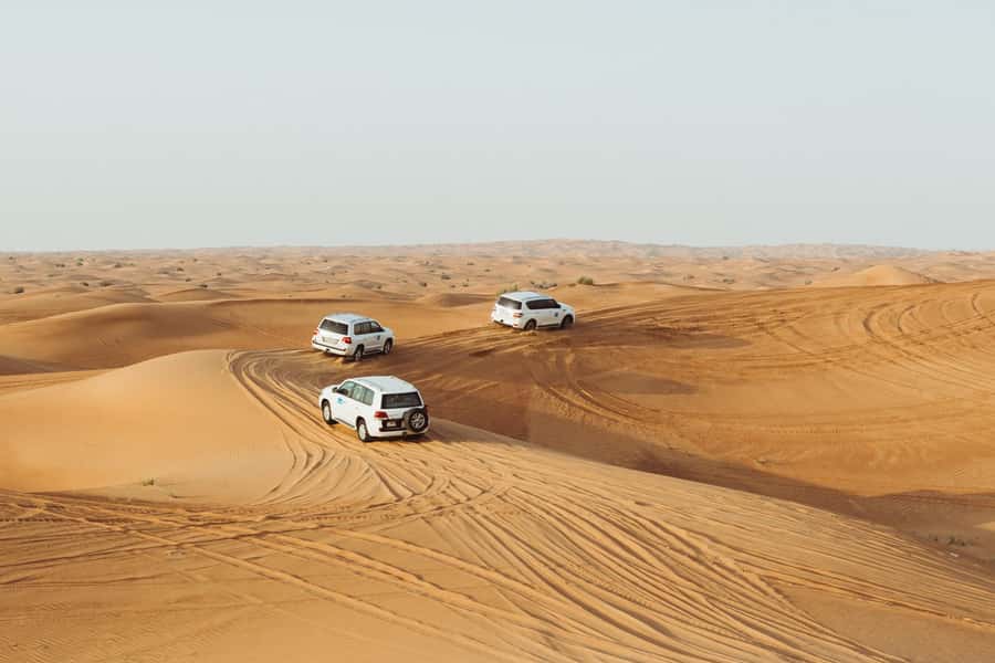 Dubai: Desert Safari, Camel Ride, and BBQ Dinner - Sunset over the sand