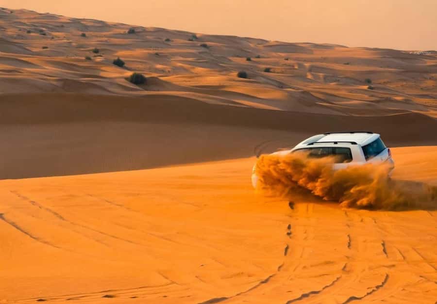 Dubai: Desert Safari, Camel Ride, Sandboard & Buffet Dinner - From Dubai streets to open desert