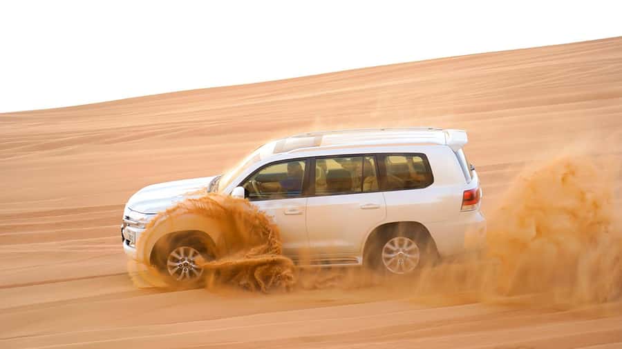 Dubai: Desert Safari, Camel Ride, Sandboarding, Quad Bike - Sandboarding on the Red Dunes