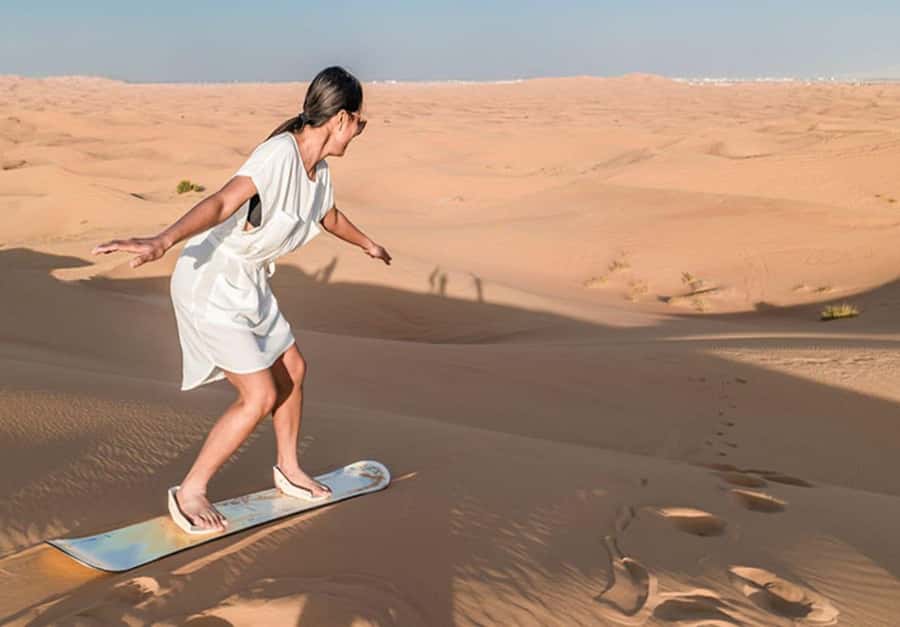 Dubai: Desert Safari Camel Riding, Sandboarding & BBQ Dinner - Sandboarding on the dunes