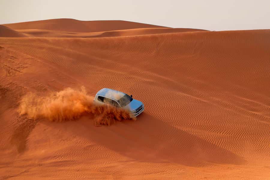 Dubai: Desert Safari, Quad Bike, Sandboarding, Camels & BBQ - From Dubai hotels to the Lehbab red dunes