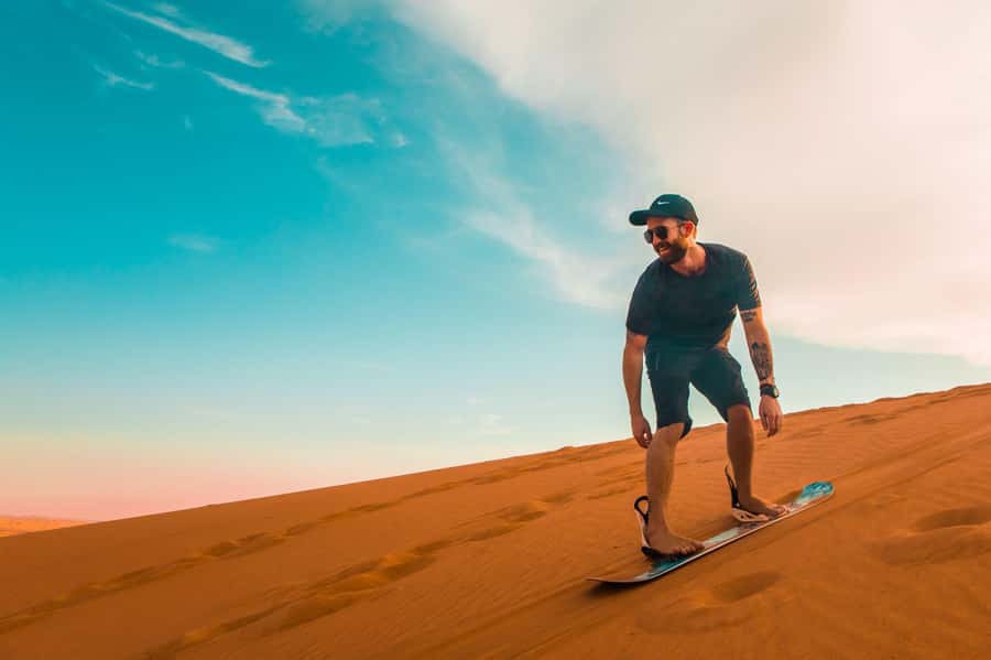 Dubai: Desert Safari, Quad Bike, Sandboarding, Camels & BBQ - Dune bashing across the red sand