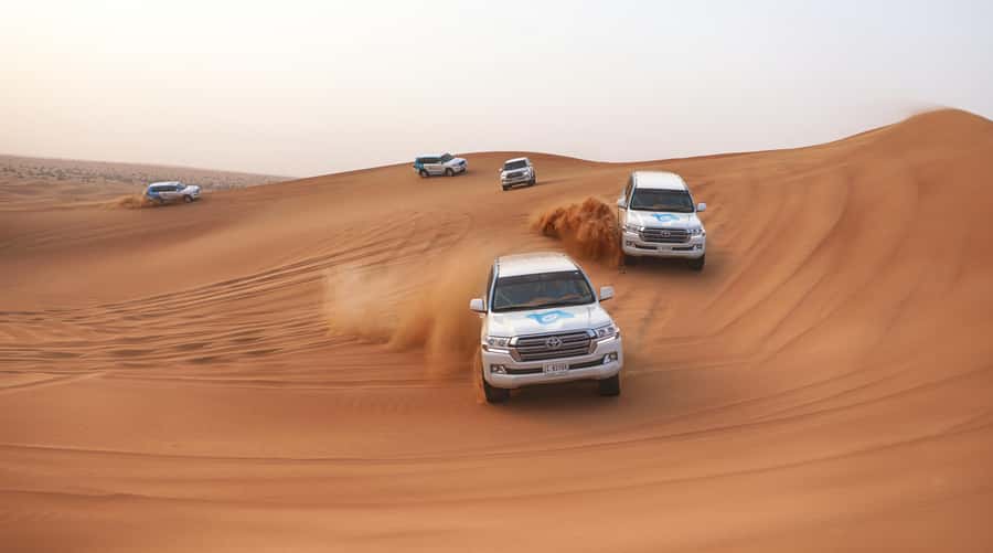 Dubai: Desert Safari with Camp, Dinner, & Optional Overnight - Dune bashing and sandboarding on the red dunes