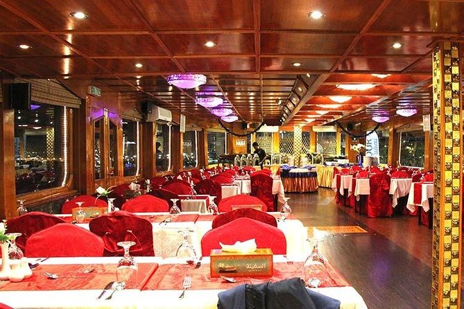 Dubai Dhow Dinner Cruise Marina with pickup drop option - A traditional dhow beneath Dubai’s modern towers