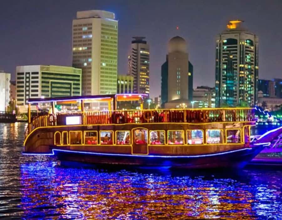 Dubai: Dhow Dinner Cruise on Creek or Marina with Live Shows - A wooden dhow with a changing city view