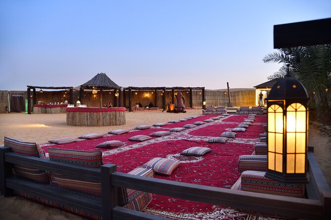 Dubai Evening Desert Safari: Sandboarding, BBQ, Camel Ride & more - A Bedouin-style camp after dark