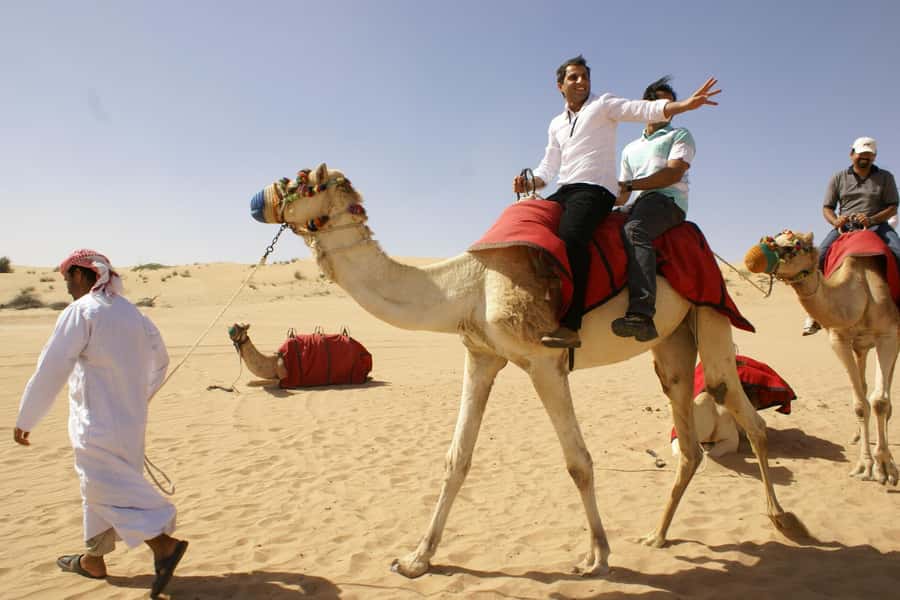 Dubai: Evening Tour with Quad Biking, Camel Ride, and BBQ - Sunset over the red sand