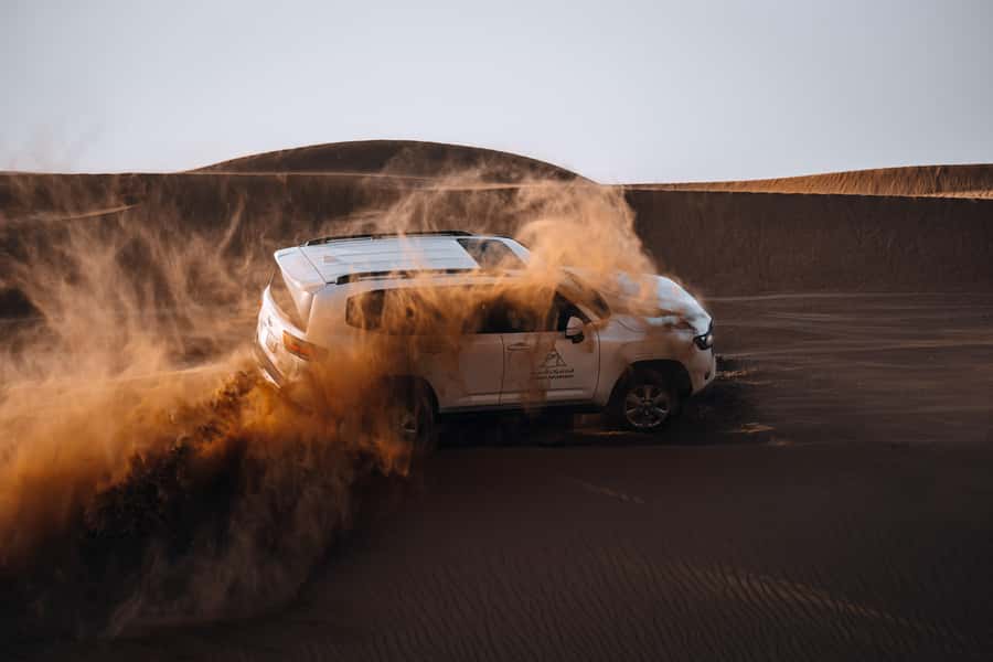 Dubai: Premium Desert Safari, Camel Ride, BBQ & Sandboarding - Sunset, soft drinks and wide desert views