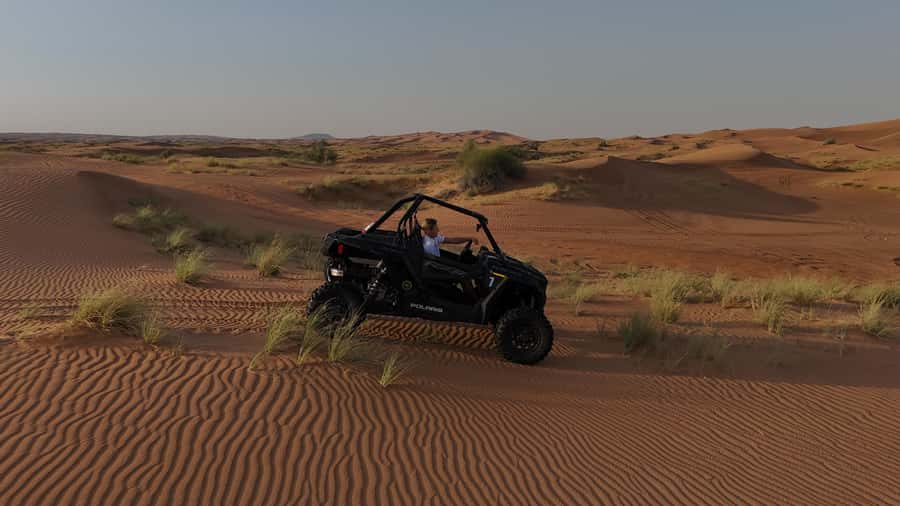Dubai: Private Dune Buggy, Camel Ride, and Sand Boarding! - Sunset turns the dunes gold and red