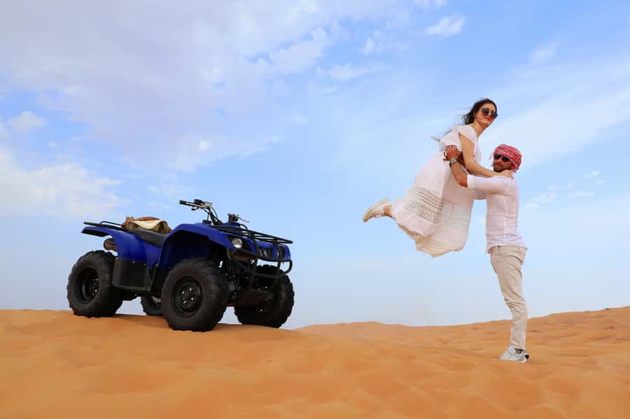 Dubai: Red Dunes Quad Bike with Sandboarding, Camels and BBQ - Pickup from Dubai, Sharjah, or Ajman