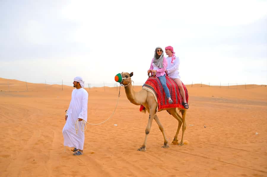 Dubai: Tour with BBQ Dinner, Camel Ride, & Traditional Show - Choosing between a gentle camp visit and dune bashing