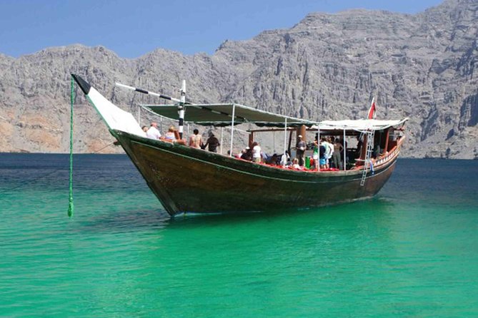 Full Day Musandam Dibba Cruise with Lunch from Dubai - Boarding the carpeted Omani dhow at Dibba