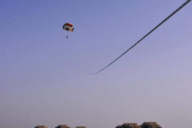 Parasailing - Harnessing up and rising above the water
